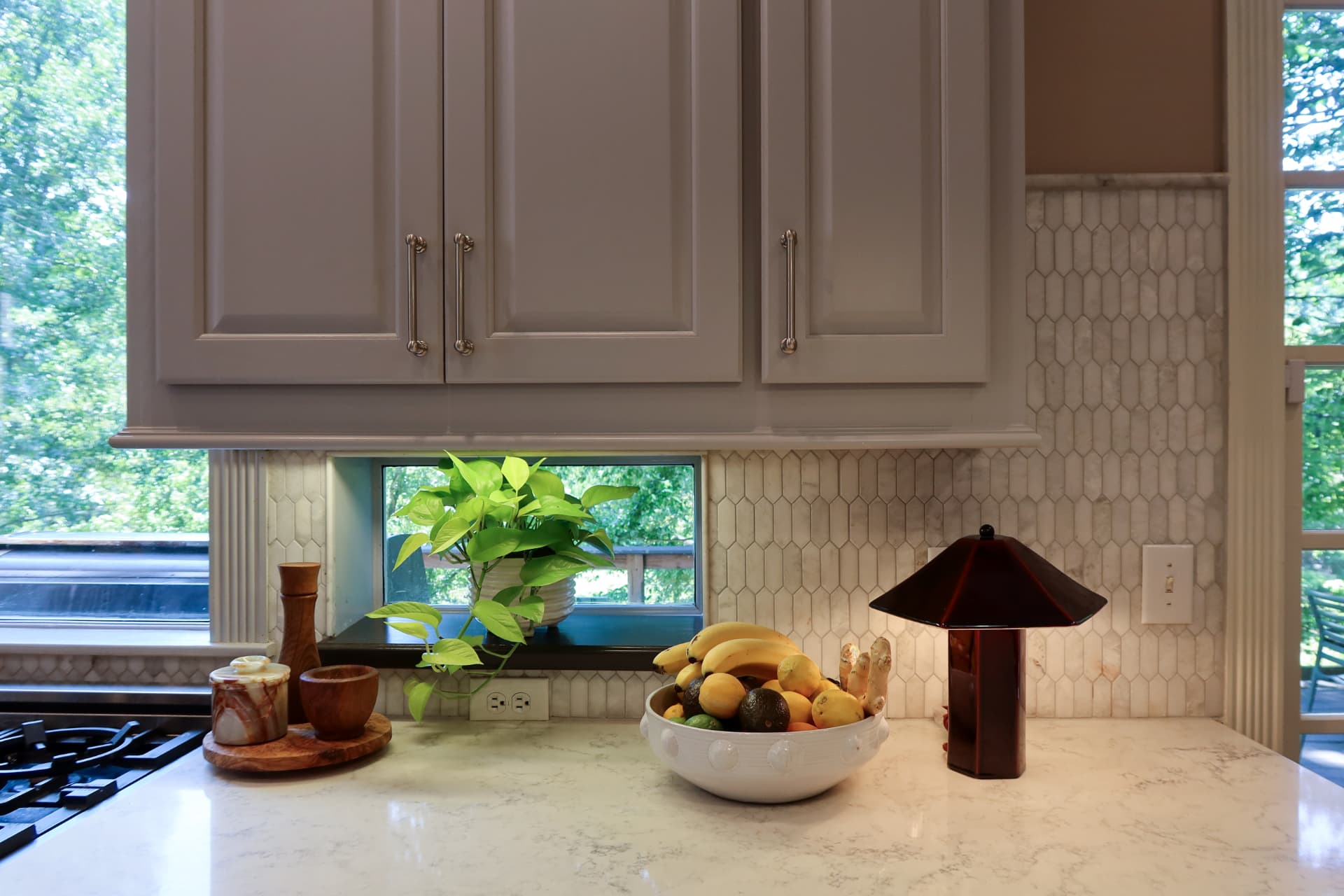 Custom Finish Work — Customized stock cabinets and marble backsplash